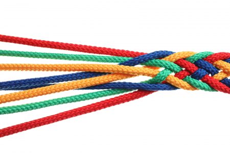 Braided colorful ropes on white background. Unity concept