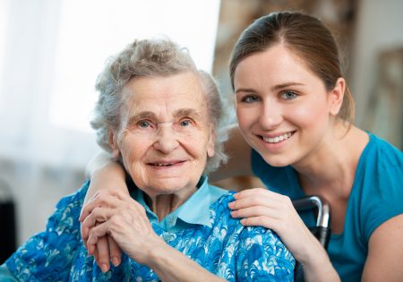 Senior woman with her caring relative at home