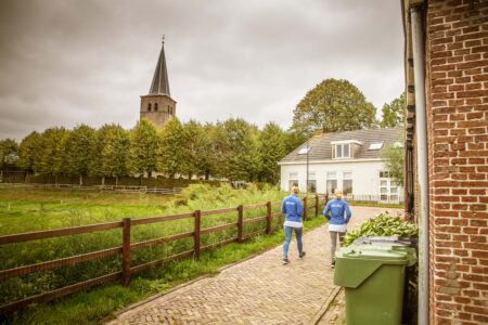 A Dutch village where two Buurtzorg nurses are walking to a house