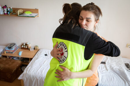 A Slovakian Red Cross volunteer comforts Larisa, a refugee from Ukraine in her apartment in Senica, Slovakia